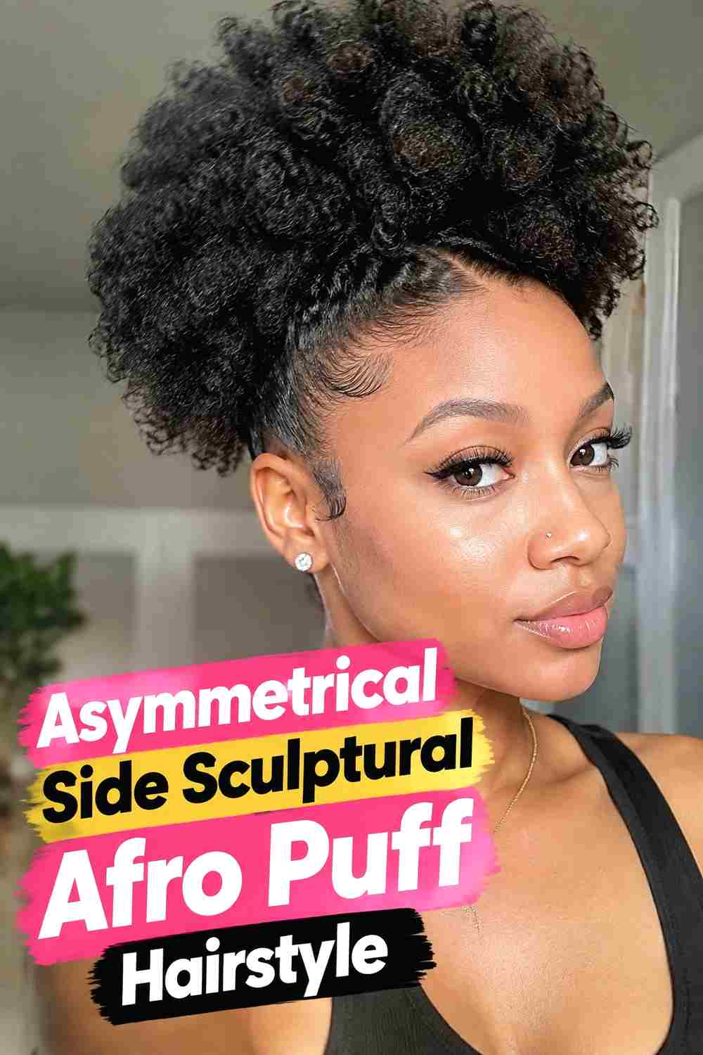 3. Asymmetrical Side Sculptural Afro Puff Hairstyle