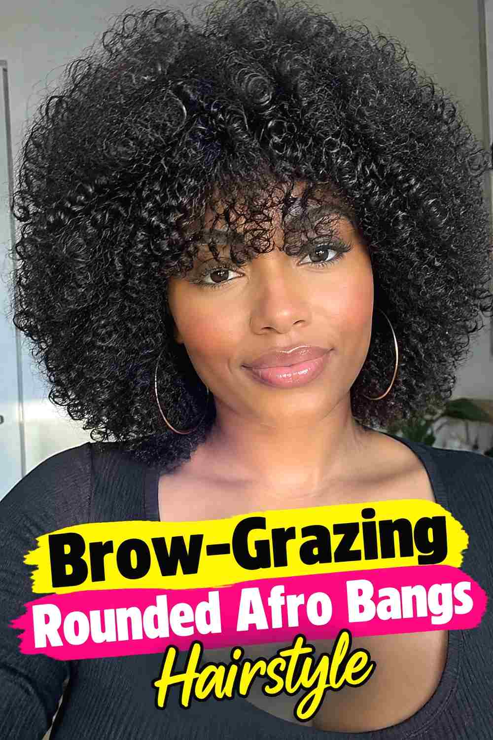 10. Brow Grazing Rounded Afro Bangs Hairstyle