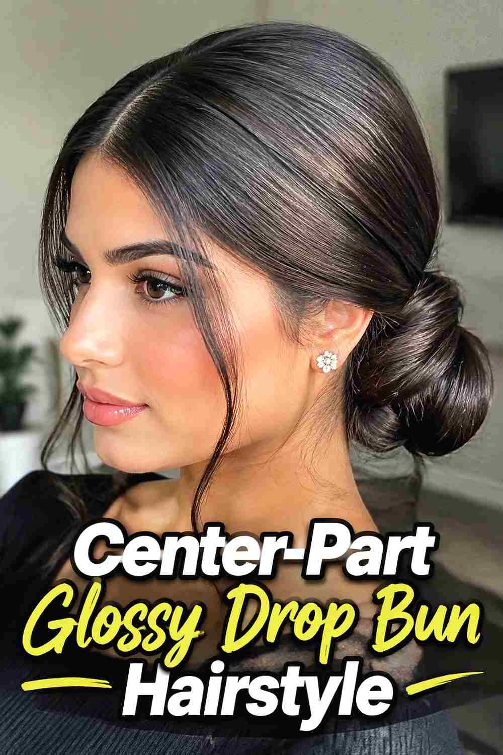 2. Center Part Glossy Drop Bun Hairstyle