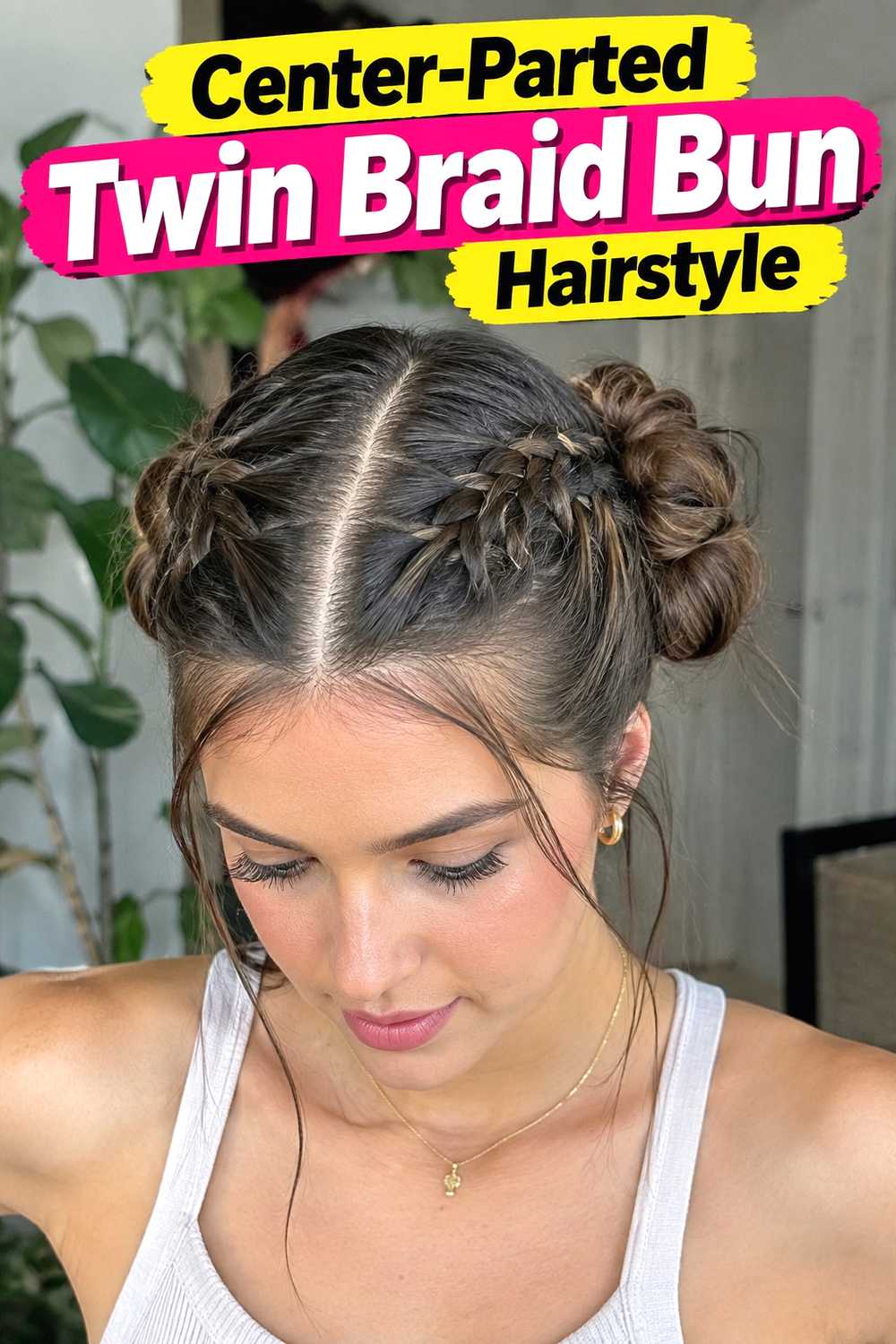 12. Center Parted Twin Braid Bun Hairstyle