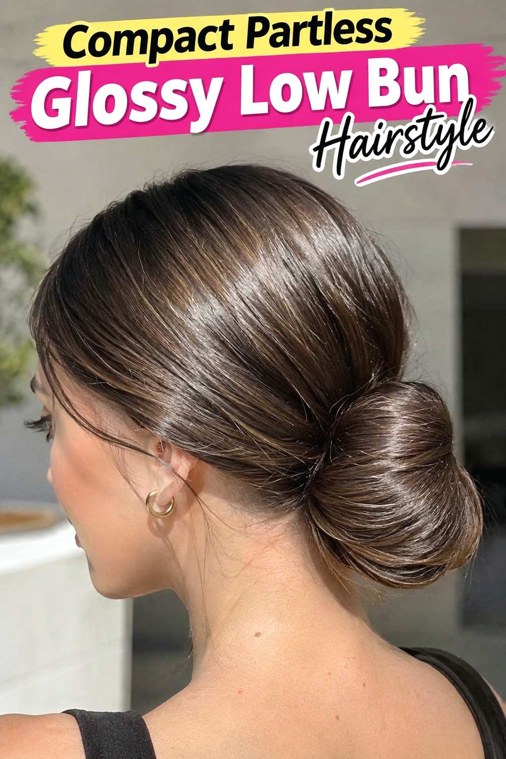7. Compact Partless Glossy Low Bun Hairstyle