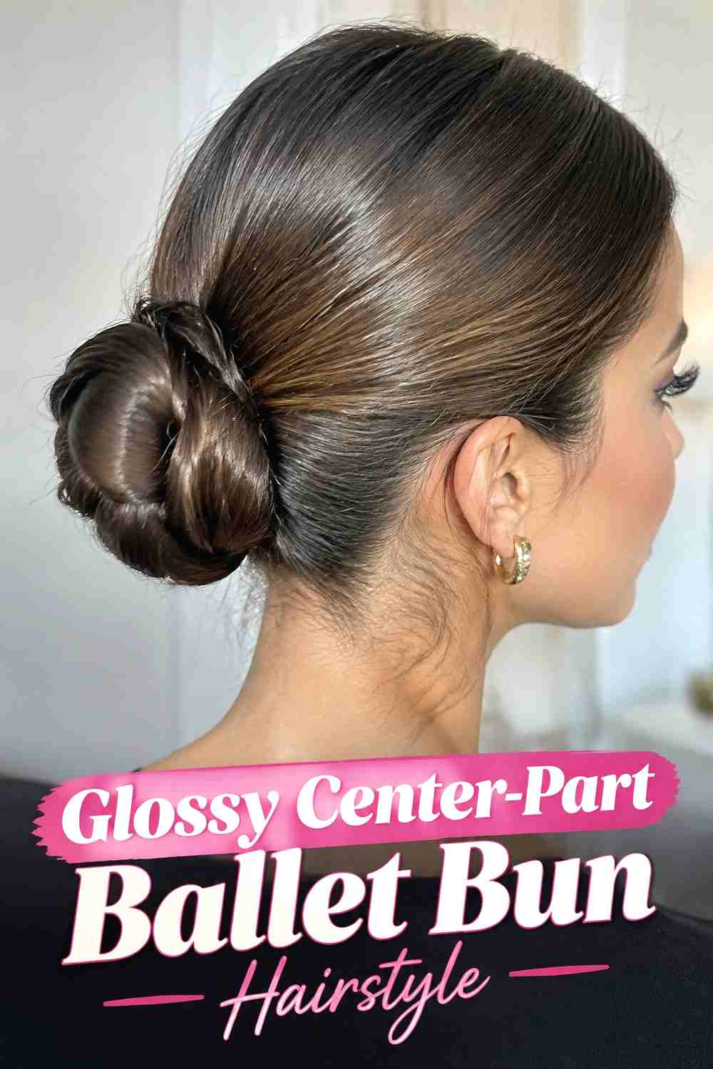 2. Glossy Center Part Ballet Bun Hairstyle
