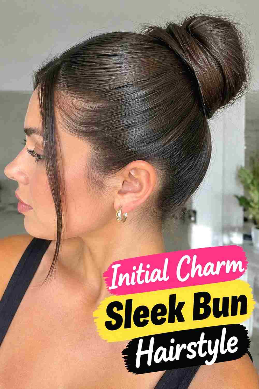 14. Initial Charm Sleek Bun Hairstyle