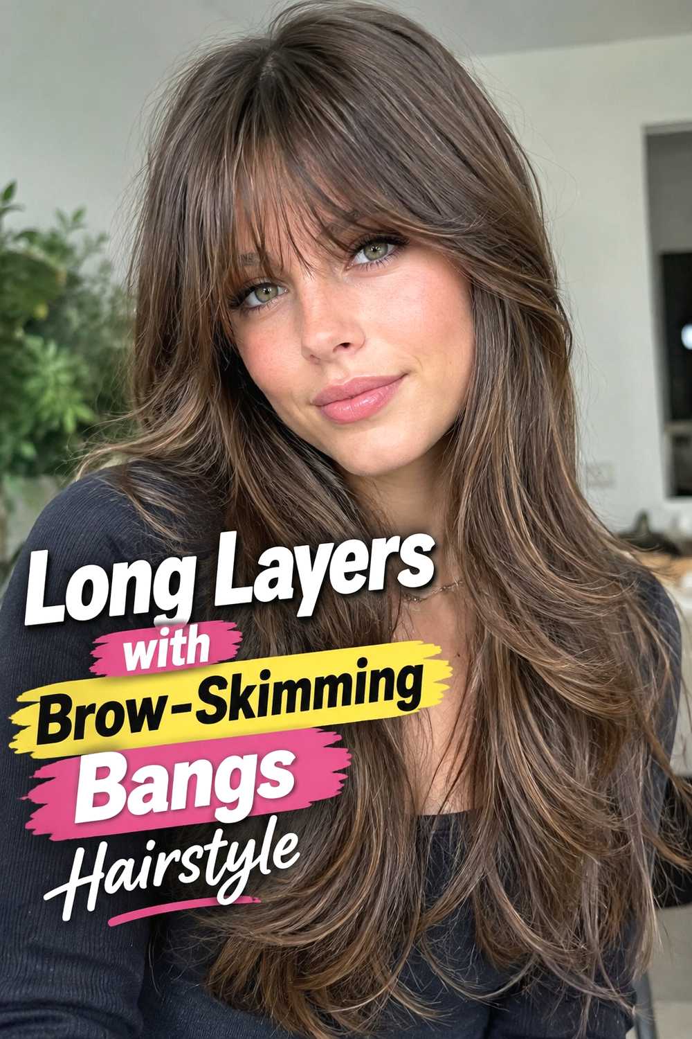 9. Long Layers With Brow Skimming Bangs Hairstyle