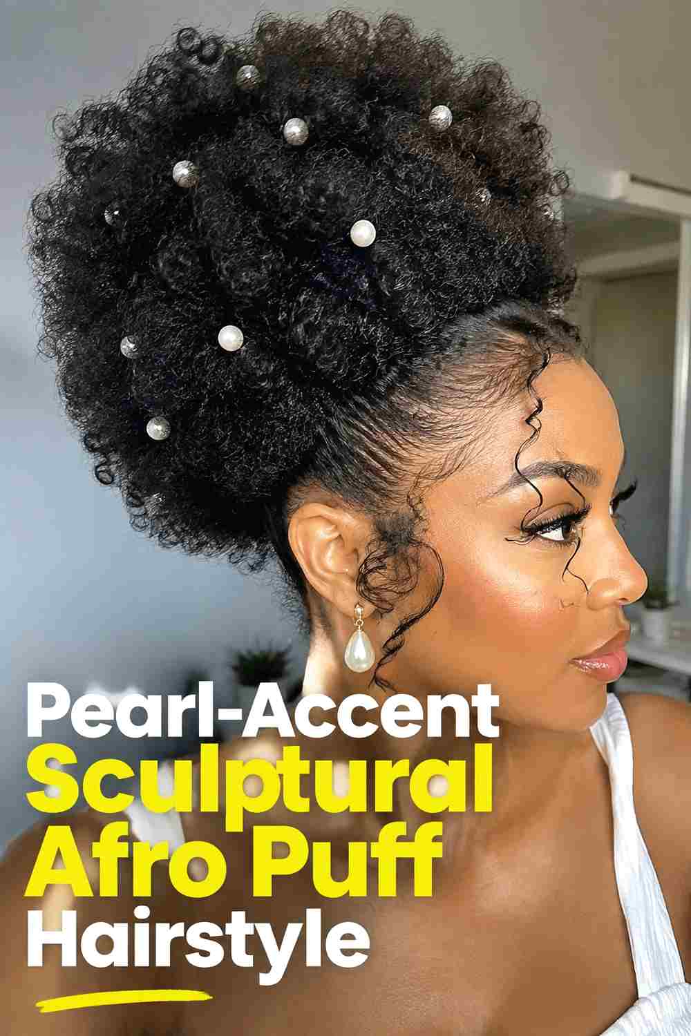 15. Pearl Accent Sculptural Afro Puff Hairstyle