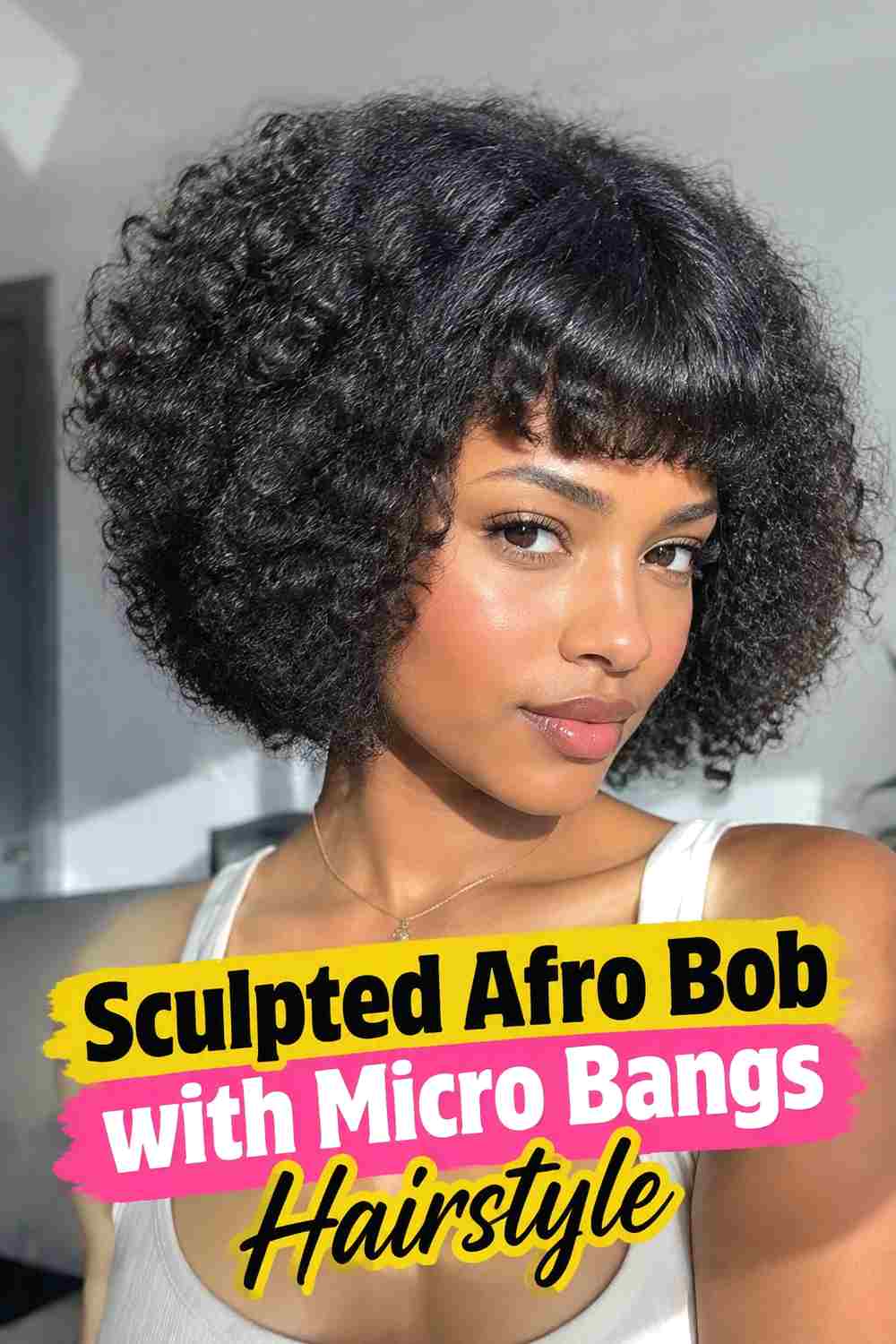 8. Sculpted Afro Bob With Micro Bangs Hairstyle