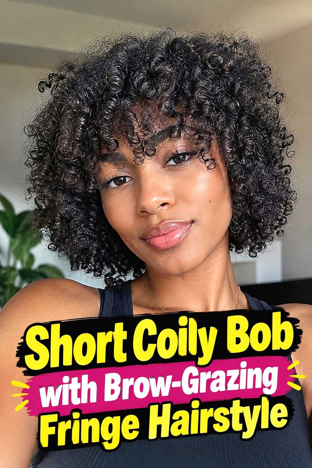 5. Short Coily Bob With Brow Grazing Fringe Hairstyle