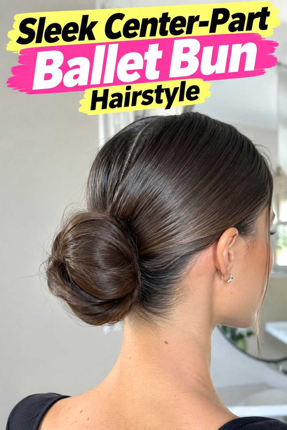 4. Sleek Center Part Ballet Bun Hairstyle