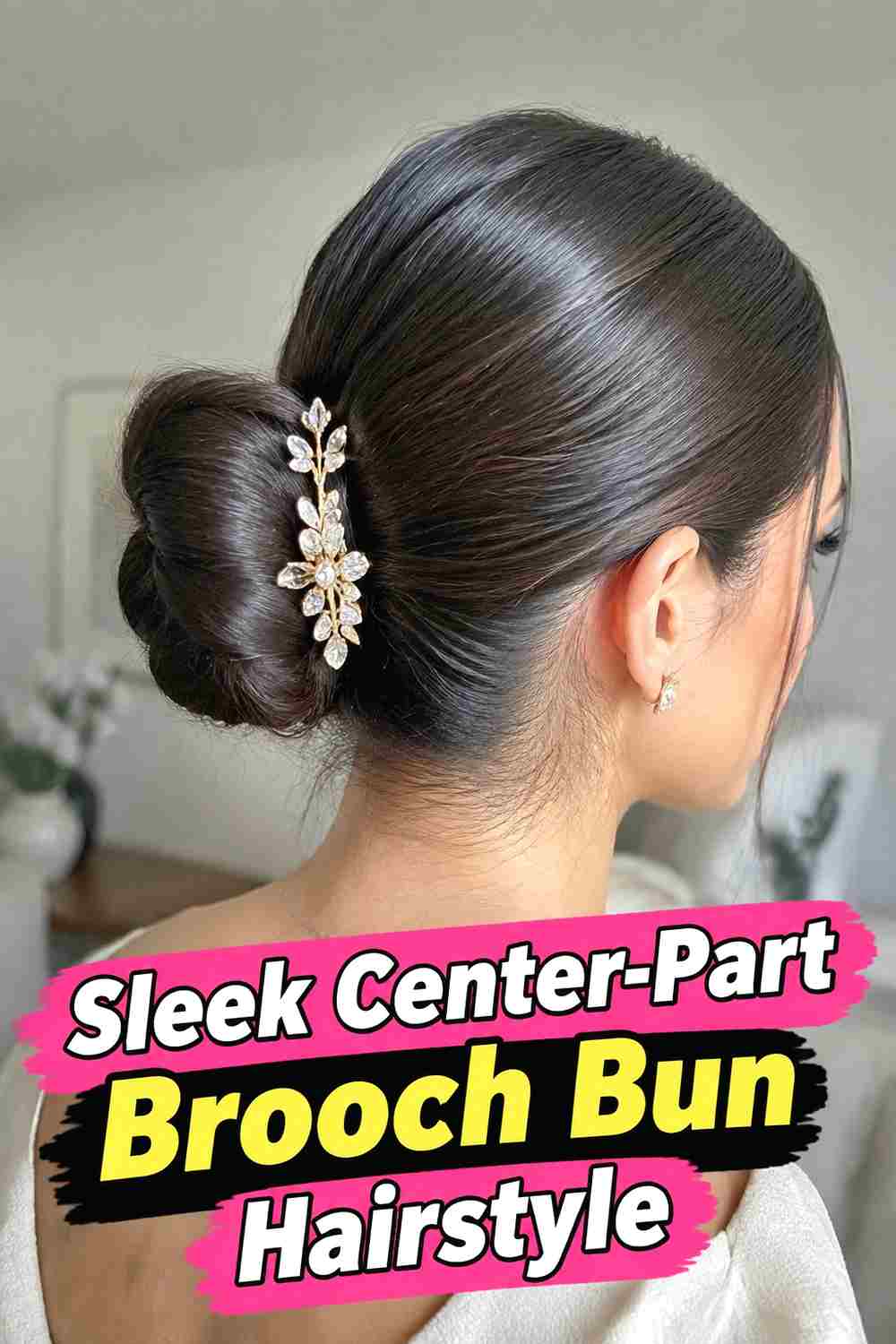 8. Sleek Center Part Brooch Bun Hairstyle