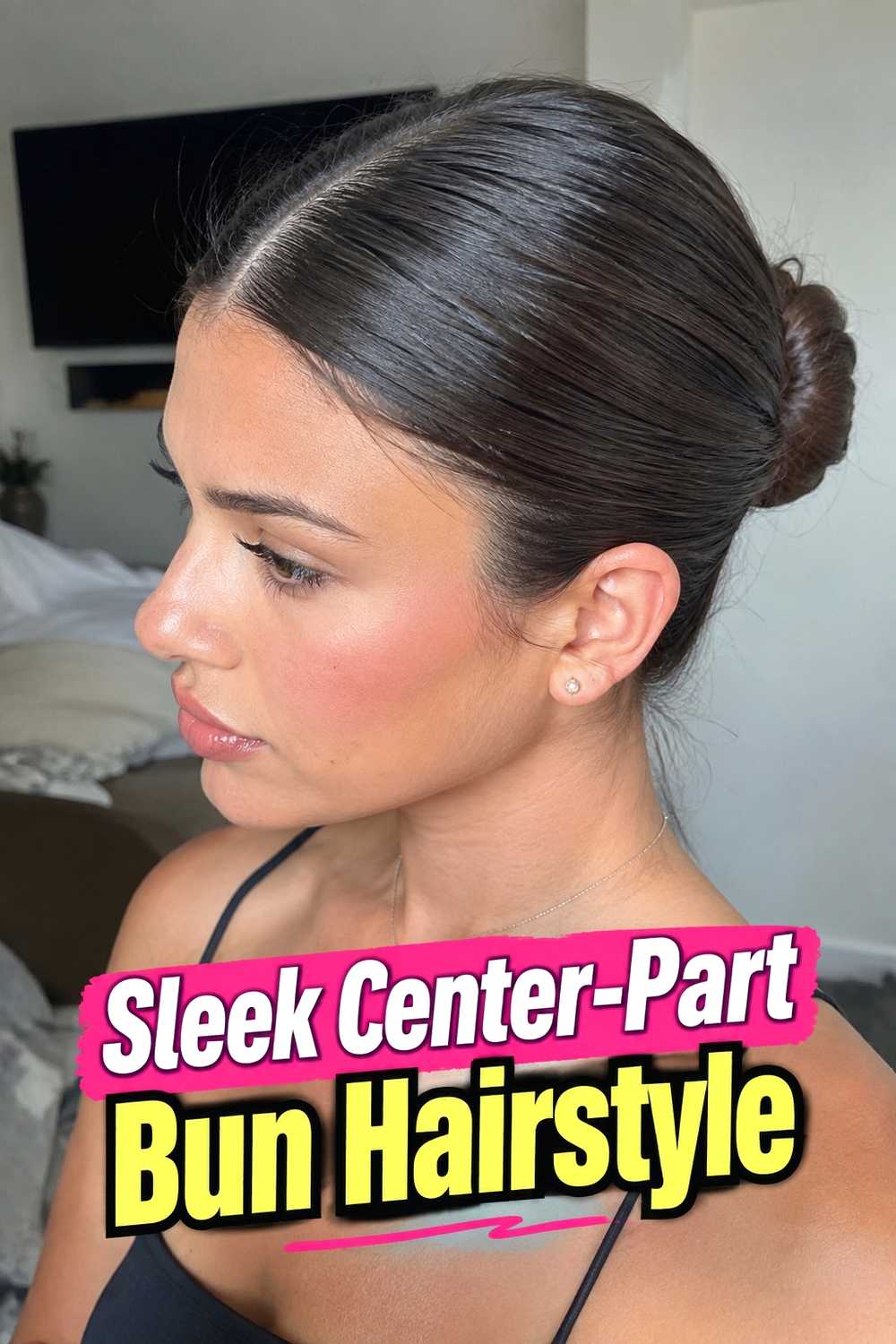 10. Sleek Center Part Bun Hairstyle