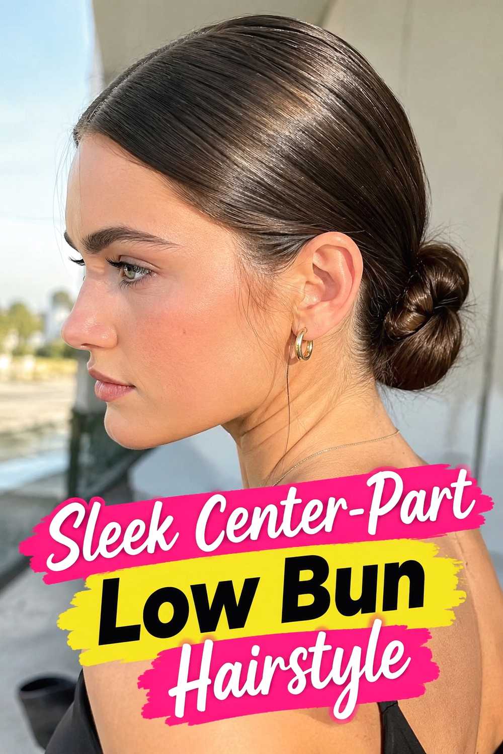 2. Sleek Center Part Low Bun Hairstyle