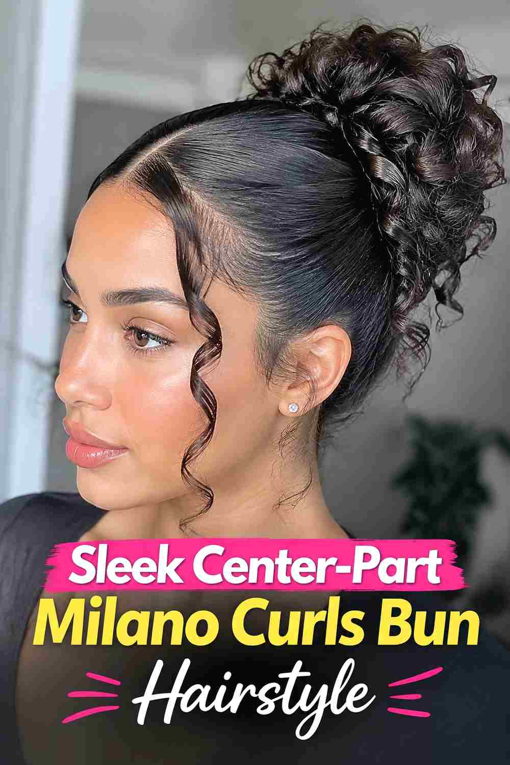 6. Sleek Center Part Milano Curls Bun Hairstyle
