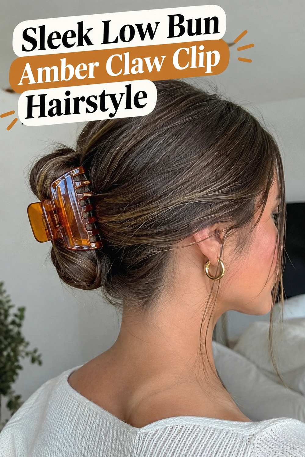 6. Sleek Low Bun Amber Claw Clip Hairstyle