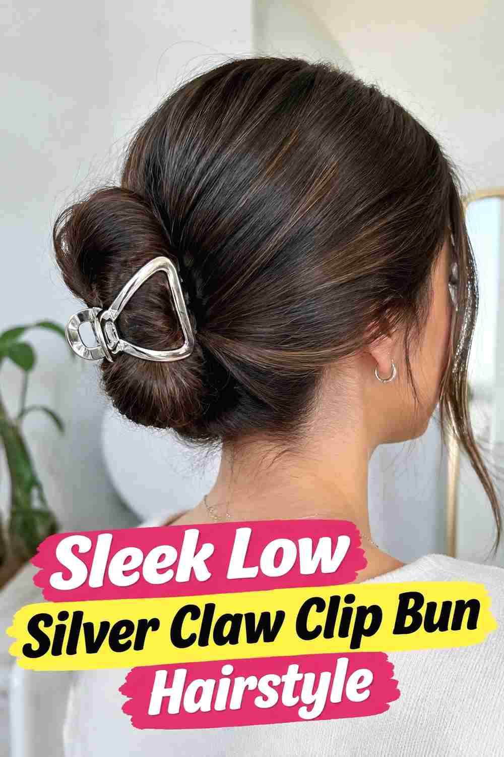 1. Sleek Low Silver Claw Clip Bun Hairstyle