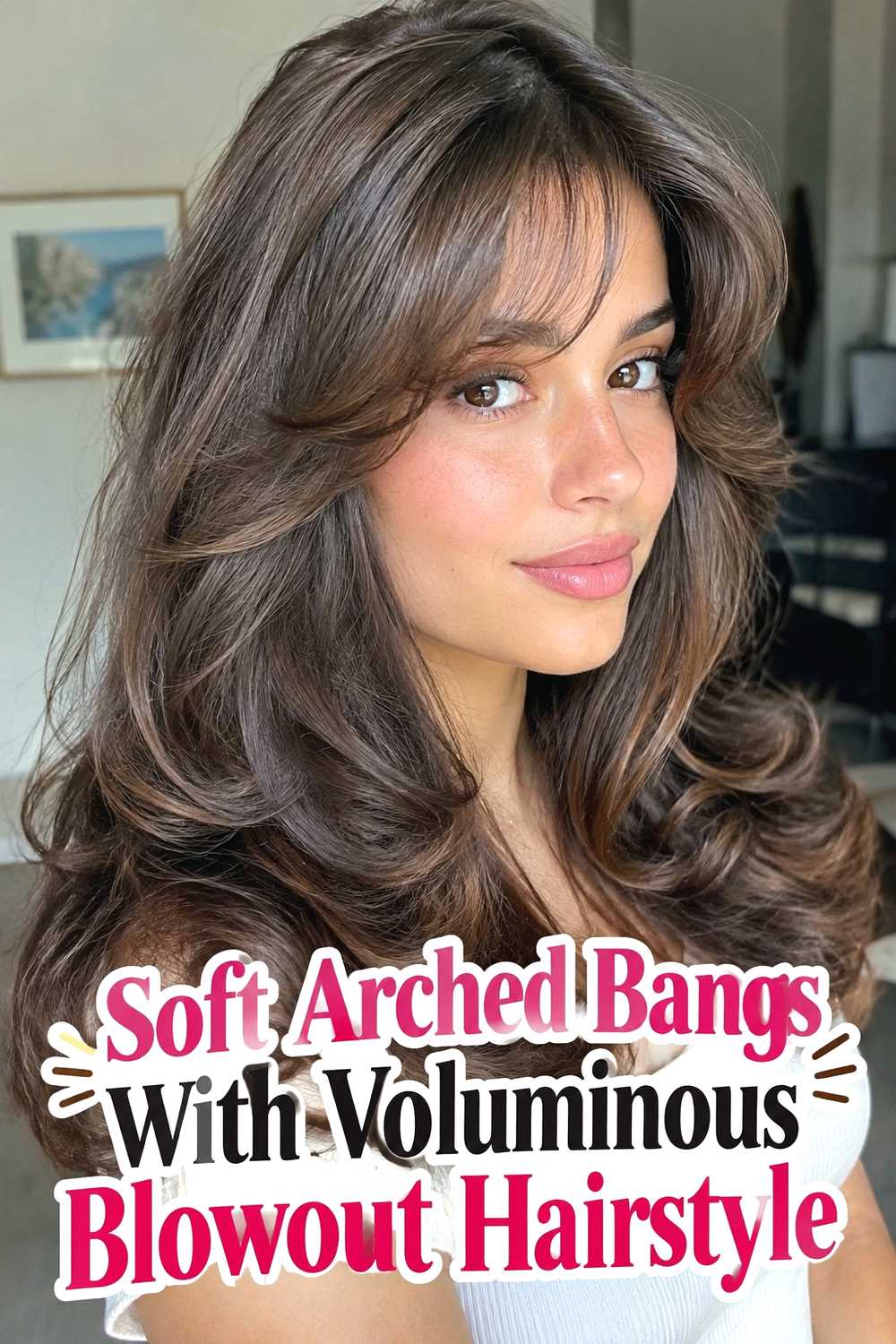13. Soft Arched Bangs With Voluminous Blowout Hairstyle