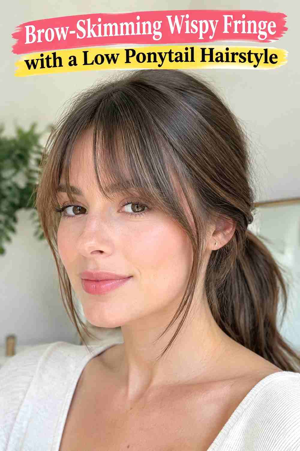 13. Brow Skimming Wispy Fringe With A Low Ponytail Hairstyle