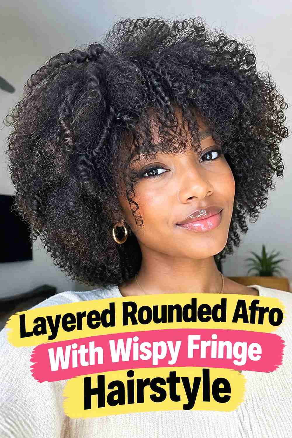 6. Layered Rounded Afro With Wispy Fringe Hairstyle