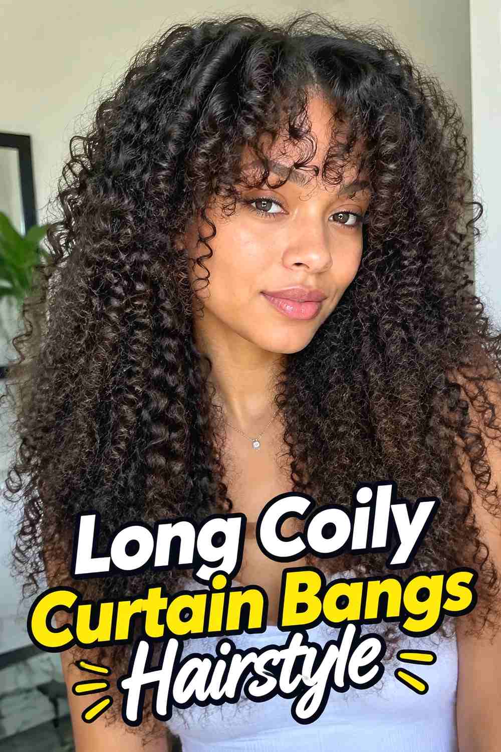 2. Long Coily Curtain Bangs Hairstyle