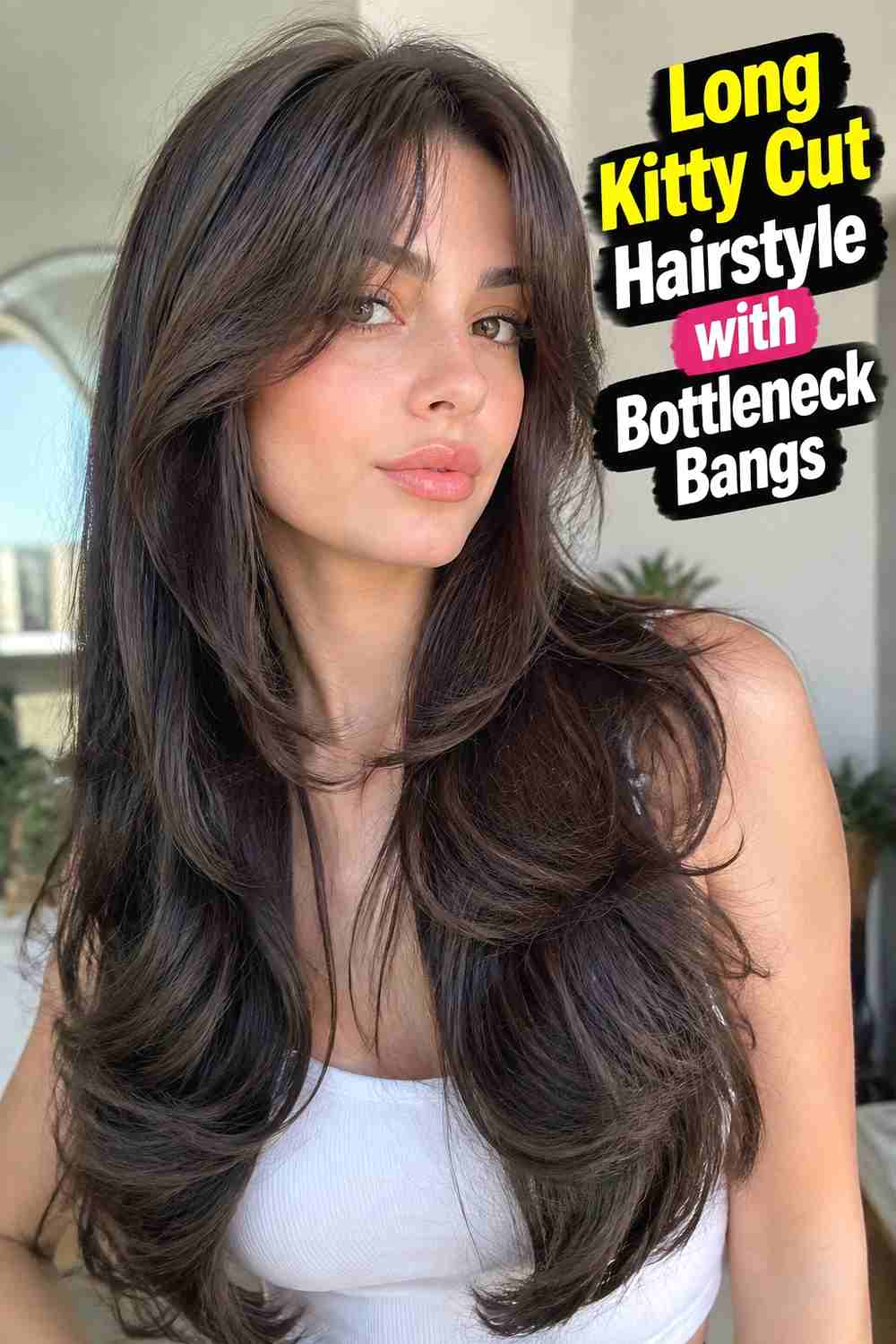 9. Long Kitty Cut Hairstyle With Bottleneck Bangs