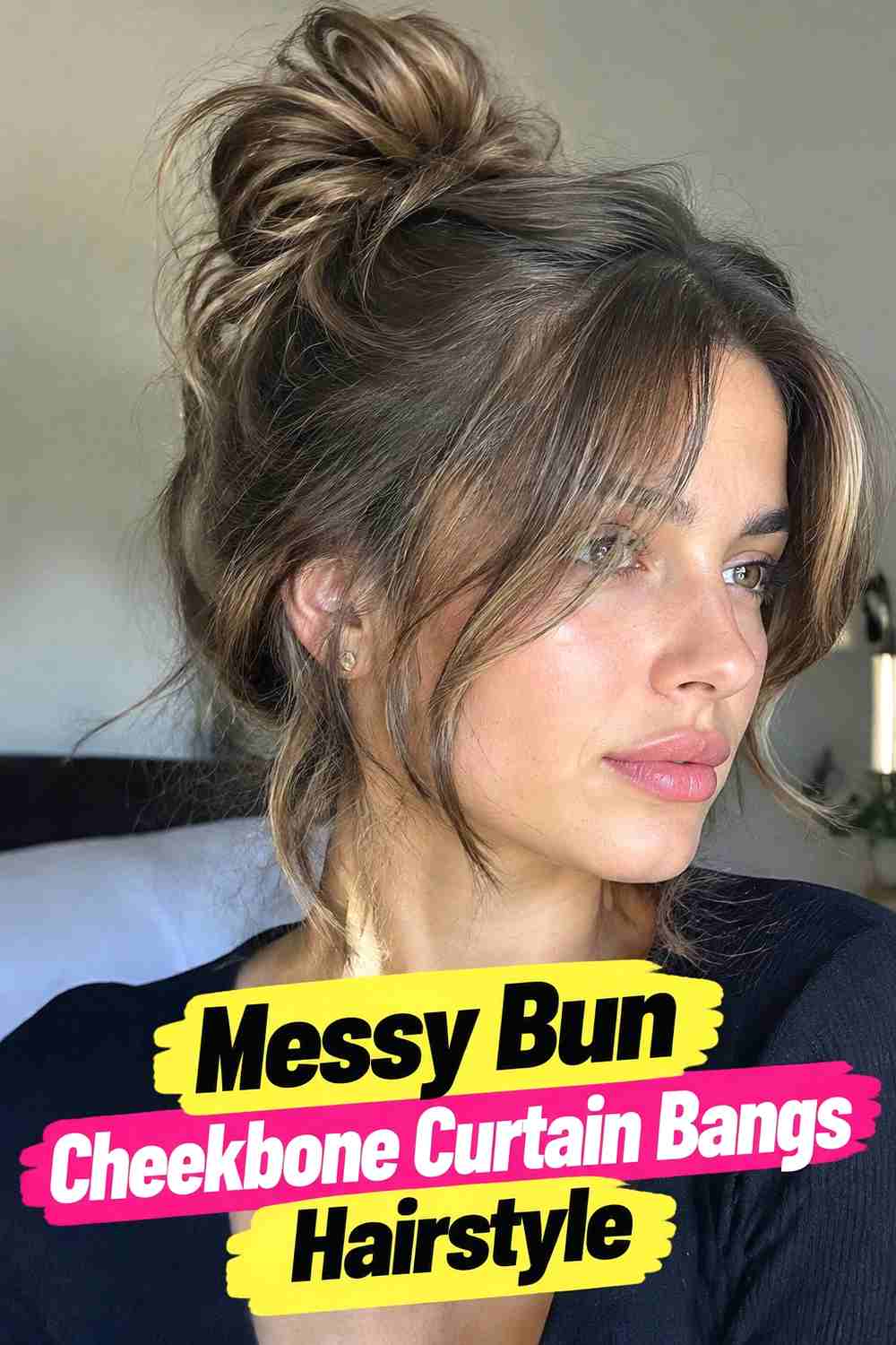 14. Messy Bun Cheekbone Curtain Bangs Hairstyle