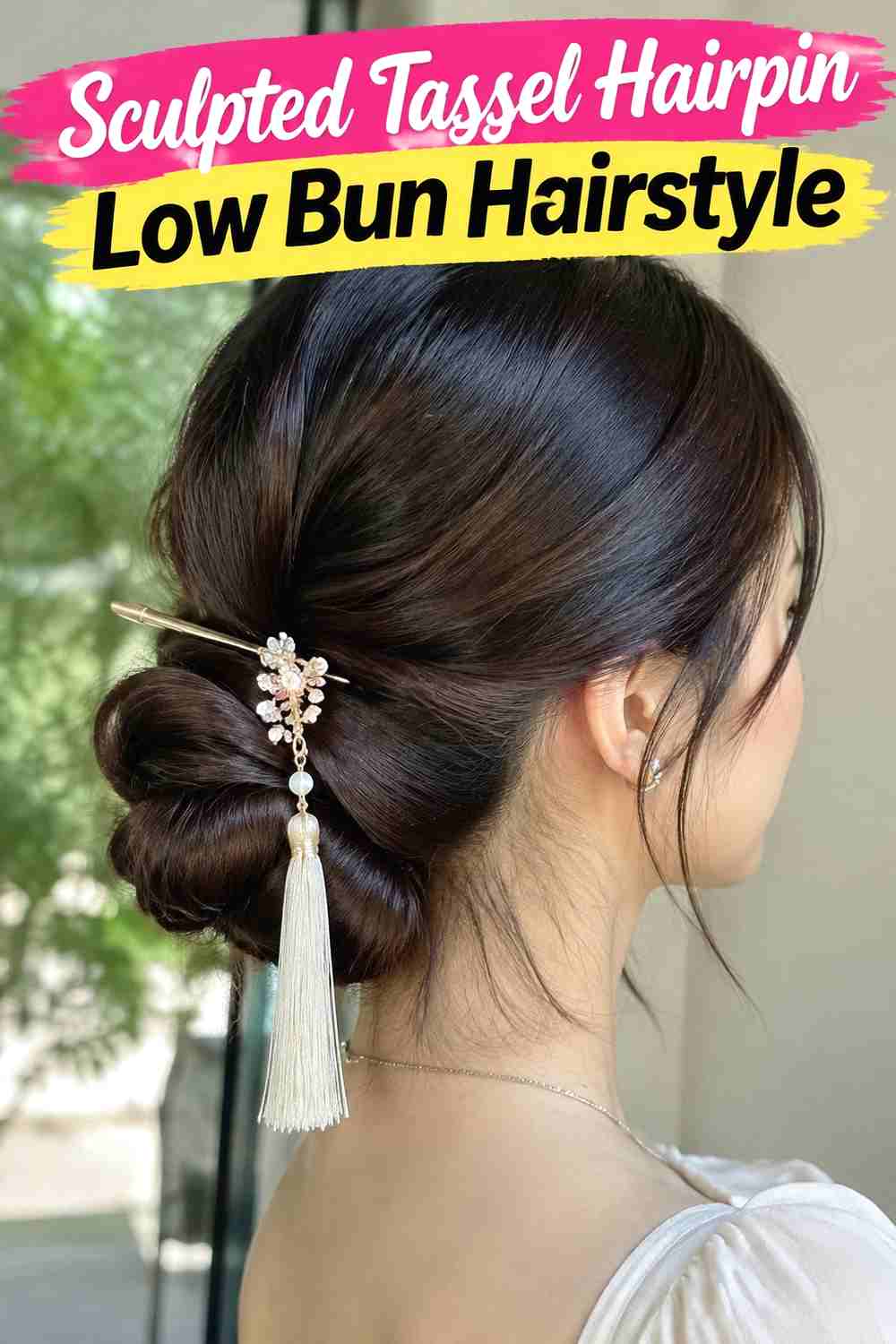 15. Sculpted Tassel Hairpin Low Bun Hairstyle