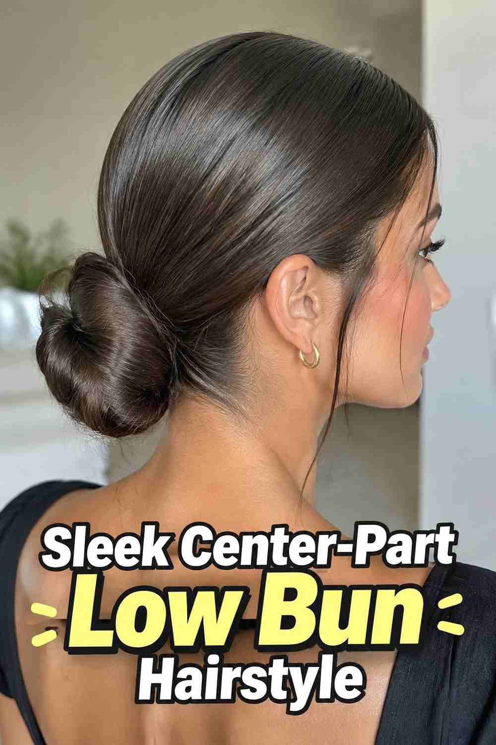 4. Sleek Center Part Low Bun Hairstyle