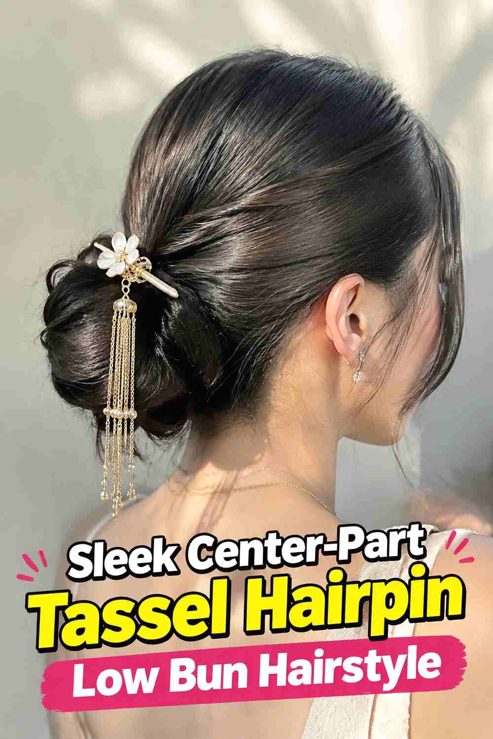 1. Sleek Center Part Tassel Hairpin Low Bun Hairstyle