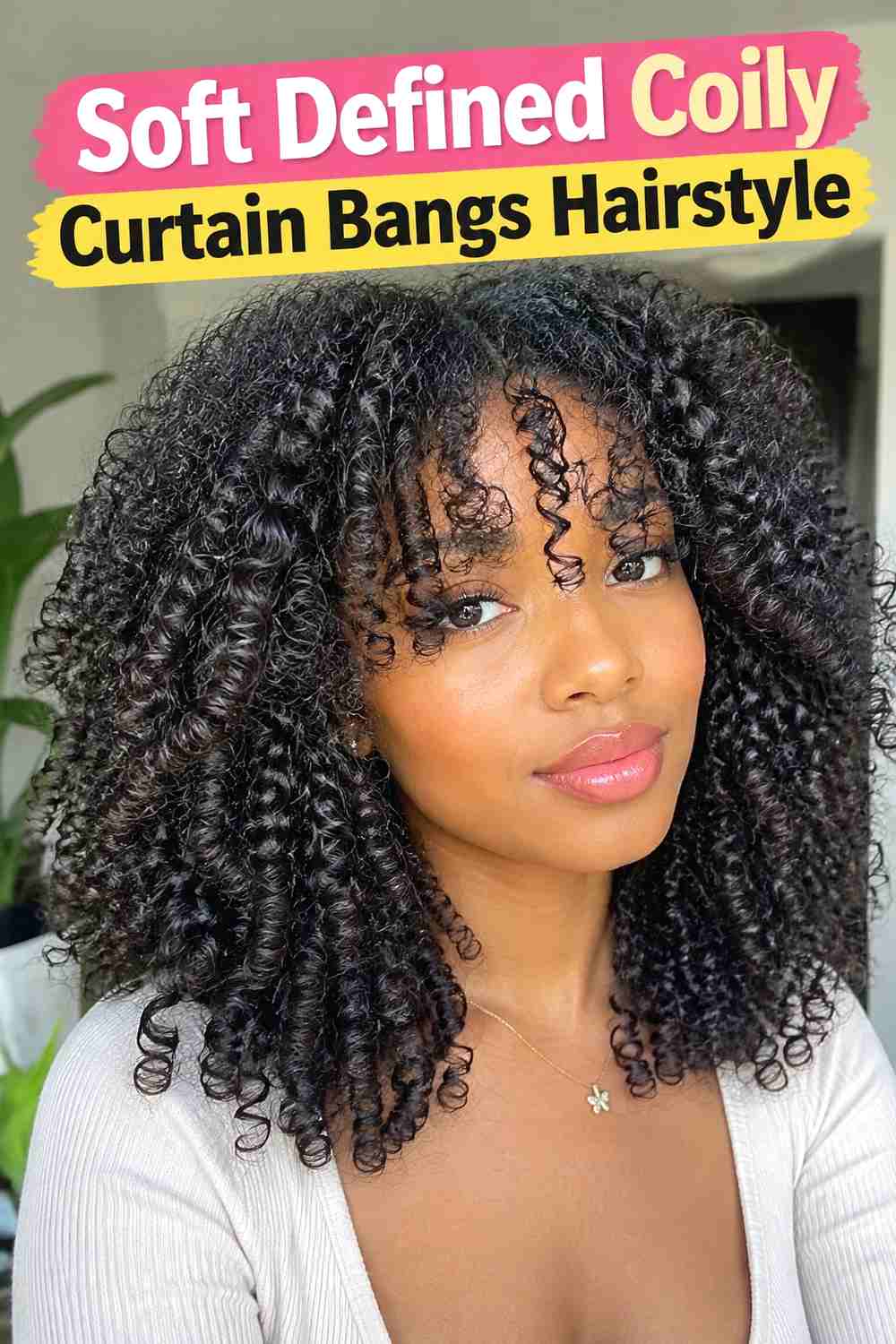 1. Soft Defined Coily Curtain Bangs Hairstyle