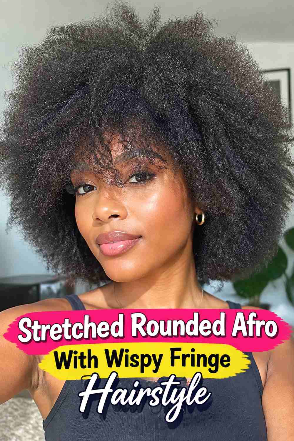 13. Stretched Rounded Afro With Wispy Fringe Hairstyle