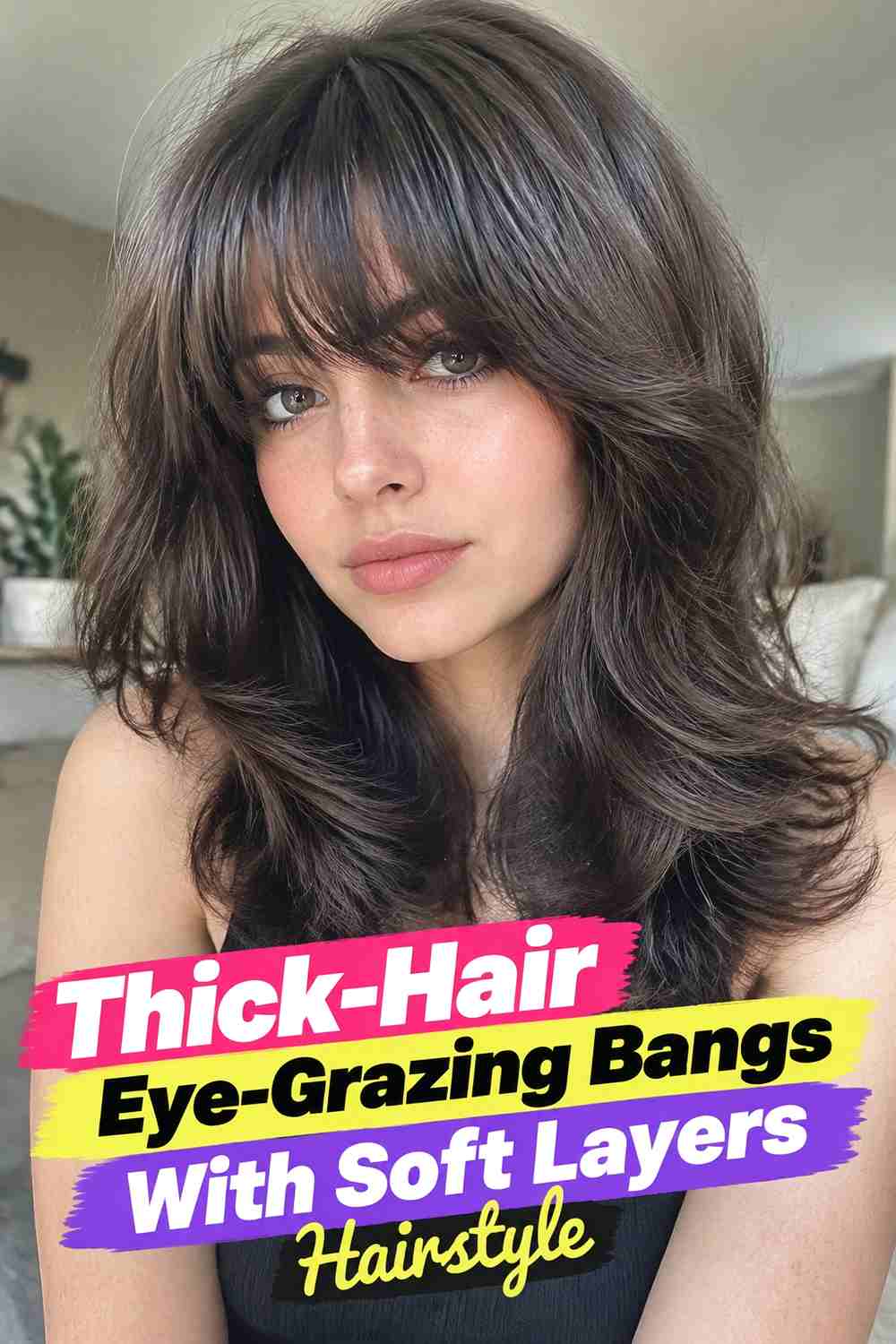 11. Thick Hair Eye Grazing Bangs With Soft Layers Hairstyle